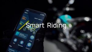 A rider using the TROMOX app to connect to their UKKO S, displaying navigation features and other smart functionalities.